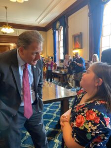 Governor Chris Sununu speaking with young girl