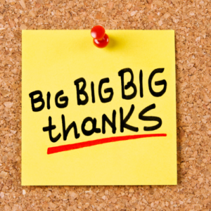 Close up of a yellow post-it note with the words Big, Big, Big Thanks underlined in red
