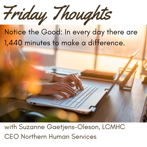 Laptop on the table next to a window with the sun streaming in and a blurred image of the hands of a person typing. Picture title: Friday Thoughts: Notice the Good: In every day there are 1,440 minutes to make a difference.